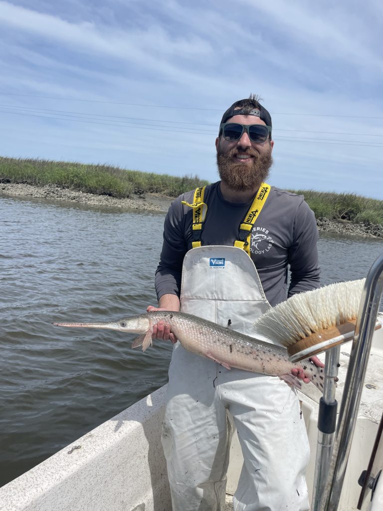 A man holding a fish in a boat